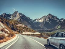 Highway Among The Mountain Scenery. White Car On A Mountain Road. Royalty Free Stock Images