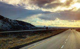 A highway runs from New Mexico through the brush and mesas of the high desert stock image A highway runs from New Mexico through the brush and mesas of the high desert stock image