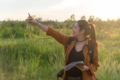 Hiker asian women walking in national park with backpack. Woman tourist going camping in meadow forest, sunset black ground royalty free stock photos Hiker asian women walking in national park with backpack. Woman tourist going camping in meadow forest, sunset black ground royalty free stock photos