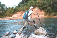 Hiker with blue backpack climbing the stone. royalty free stock image Hiker with blue backpack climbing the stone. royalty free stock image