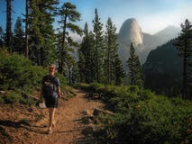 Hiker Walking on Trail Towards the Half Dome, Yosemite National Park, California stock images Hiker Walking on Trail Towards the Half Dome, Yosemite National Park, California stock images