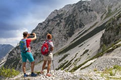 Hikers walking on hike in mountain nature landscape and taking photos royalty free stock photography Hikers walking on hike in mountain nature landscape and taking photos royalty free stock photography