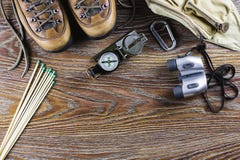 Hiking Equipment With Boots, Compass, Binoculars, Matches, Travel Bag On Wooden Background. Active Lifestyle Concept. Stock Image