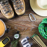 Hiking Equipment With Boots, Compass, Binoculars, Matches, Travel Bag On Wooden Background. Active Lifestyle Concept. Royalty Free Stock Images