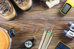Hiking Or Travel Equipment With Boots, Compass, Binoculars, Matches On Wooden Background. Active Lifestyle Concept Stock Image