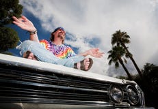Hippie Meditating On Car Hood Stock Photography