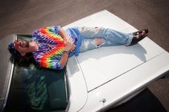 Hippie On A Car Hood Royalty Free Stock Image