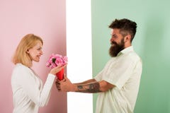 Hipster bearded give bouquet flowers to girlfriend. Man with beard congratulates woman birthday anniversary holiday stock photos Hipster bearded give bouquet flowers to girlfriend. Man with beard congratulates woman birthday anniversary holiday stock photos