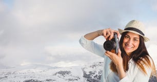 Hipster clicking photographs by snowcapped mountains against sky. Digital composite of Hipster clicking photographs by snowcapped mountains against sky Stock Photo Hipster clicking photographs by snowcapped mountains against sky. Digital composite of Hipster clicking photographs by snowcapped mountains against sky Stock Photo