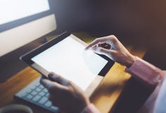 Hipster girl using tablet technology in home atmosphere, person holding computer on background glow bokeh Christmas illumination, stock photo Hipster girl using tablet technology in home atmosphere, person holding computer on background glow bokeh Christmas illumination, stock photo