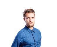Hipster man in blue long-sleeved shirt, studio shot, isolated. Hipster man in blue long-sleeved shirt, studio shot on white background, isolated Stock Images Hipster man in blue long-sleeved shirt, studio shot, isolated. Hipster man in blue long-sleeved shirt, studio shot on white background, isolated Stock Images