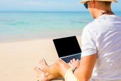 Man with laptop on the beach stock photography Man with laptop on the beach stock photography