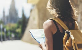 Hipster young girl with bright backpack and fashion sunglasses looking at map. Said view tourist traveler on background sun city royalty free stock photo Hipster young girl with bright backpack and fashion sunglasses looking at map. Said view tourist traveler on background sun city royalty free stock photo