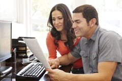 Hispanic couple working in home office Stock Photo Hispanic couple working in home office Stock Photo