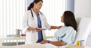 Hispanic doctor talking to patient in hospital bed royalty free stock images Hispanic doctor talking to patient in hospital bed royalty free stock images