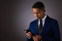Hispanic Teenager Dressed Well Dressed In Suit, And Using Cellphone, Smartphone Royalty Free Stock Image