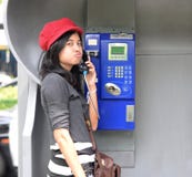 Hispanic Woman Talking In A Public Phone Royalty Free Stock Photo