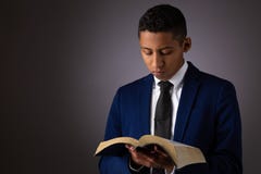 Hispanic Young Teenager Boy Searching The Scriptures, The Word Of God, The Bible Stock Image