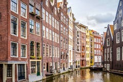 Historic houses on the Ouderzijds Achterburgwal canal in the red light district of the old city center of Amsterdam stock photo Historic houses on the Ouderzijds Achterburgwal canal in the red light district of the old city center of Amsterdam stock photo