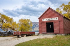 Historic Red Railway Shed At Glenorchy With Mountain And Golden Fall Colors Foliage Background Royalty Free Stock Images