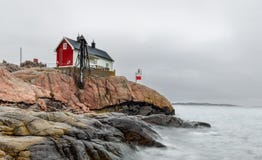 Historical building and small lighthouse in the area of Femöre, Sweden