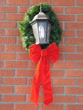 Holiday Bow Around An Outdoor Light Royalty Free Stock Images