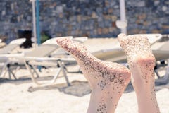 Holiday concept. Woman feet close-up relaxing on beach, enjoying sun and splendid view stock photo Holiday concept. Woman feet close-up relaxing on beach, enjoying sun and splendid view stock photo