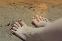 Holiday concept. Woman feet close-up relaxing on beach, enjoying sun and splendid view royalty free stock image Holiday concept. Woman feet close-up relaxing on beach, enjoying sun and splendid view royalty free stock image