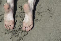 Holiday concept. Woman feet close-up relaxing on beach, enjoying sun and splendid view stock image Holiday concept. Woman feet close-up relaxing on beach, enjoying sun and splendid view stock image