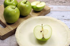 Holiday festive baking with an empty pie shell pastry crust with raw green apples Royalty Free Stock Photos Holiday festive baking with an empty pie shell pastry crust with raw green apples Royalty Free Stock Photos