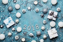 Holiday frame with christmas decoration, gift box, confetti and sequins on vintage blue table top view. Flat lay. New year 2018. Stock Image Holiday frame with christmas decoration, gift box, confetti and sequins on vintage blue table top view. Flat lay. New year 2018. Stock Image