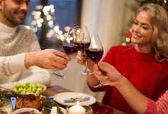 Close up of friends with wine celebrate christmas stock photo Close up of friends with wine celebrate christmas stock photo