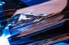 Holographic plastic wrinkled film with contrast sun light reflections. Blue tones with dark black shadows royalty free stock photo Holographic plastic wrinkled film with contrast sun light reflections. Blue tones with dark black shadows royalty free stock photo