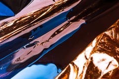 Holographic plastic wrinkled film with contrast sun light reflections. Blue tones with dark black shadows royalty free stock photos Holographic plastic wrinkled film with contrast sun light reflections. Blue tones with dark black shadows royalty free stock photos
