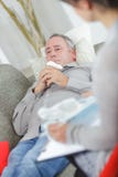 Hombre de mediana edad emocional que habla con el terapeuta fotos de archivo libres de regalías Hombre de mediana edad emocional que habla con el terapeuta fotos de archivo libres de regalías