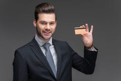 hombre de negocios alegre hermoso que sostiene la tarjeta de crédito de oro, fotos de archivo libres de regalías hombre de negocios alegre hermoso que sostiene la tarjeta de crédito de oro, fotos de archivo libres de regalías