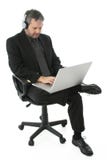 Hombre de negocios con la computadora portátil y los auriculares Imagen de archivo