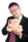 Hombre de negocios con un oso de peluche Fotografía de archivo libre de regalías Hombre de negocios con un oso de peluche Fotografía de archivo libre de regalías