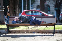 Homeless Man Sleeping On The Bench. Poverty Stock Photos Homeless Man Sleeping On The Bench. Poverty Stock Photos