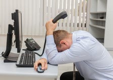 Homem de negócio novo com problemas e esforço no escritório que senta-se na frente do computador imagem de stock Homem de negócio novo com problemas e esforço no escritório que senta-se na frente do computador imagem de stock