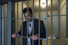 Homem de negócios Standing Behind Bars foto de stock royalty free Homem de negócios Standing Behind Bars foto de stock royalty free