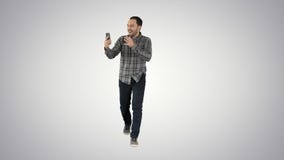Homem entusiasmado que usa o vlog video do blogue da gravação do smartphone no fundo do inclinação imagem de stock Homem entusiasmado que usa o vlog video do blogue da gravação do smartphone no fundo do inclinação imagem de stock