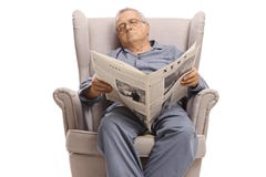 Homem idoso com um jornal que dorme em uma poltrona fotos de stock Homem idoso com um jornal que dorme em uma poltrona fotos de stock