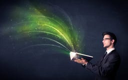 Homem novo que guarda o livro com onda Imagem de Stock Homem novo que guarda o livro com onda Imagem de Stock