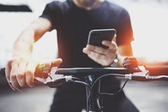 Homem Tattooed do moderno em guardar as mãos do smartphone e em usar o app dos mapas antes de montar pelo 'trotinette' elétrico n imagem de stock Homem Tattooed do moderno em guardar as mãos do smartphone e em usar o app dos mapas antes de montar pelo 'trotinette' elétrico n imagem de stock
