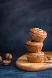 Homemade delicious muffin on dark background close-up. Cup cakes with banana and walnut. Side view, copy space stock image Homemade delicious muffin on dark background close-up. Cup cakes with banana and walnut. Side view, copy space stock image