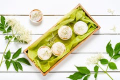 Homemade elderberry blossom muffins with sugar icing and fresh elder flowers. royalty free stock photos Homemade elderberry blossom muffins with sugar icing and fresh elder flowers. royalty free stock photos