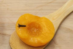 Homemade peach compote spiced with cloves in a glass bowl on wooden spoon and background stock photos Homemade peach compote spiced with cloves in a glass bowl on wooden spoon and background stock photos
