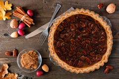 Pecan pie, top view table scene over wood stock photos Pecan pie, top view table scene over wood stock photos