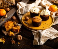 Homemade Tasty Sweet Orange Pumpkin Muffins Or Cupcakes With White Cream, Lavender, Zest, Nuts Stock Photography